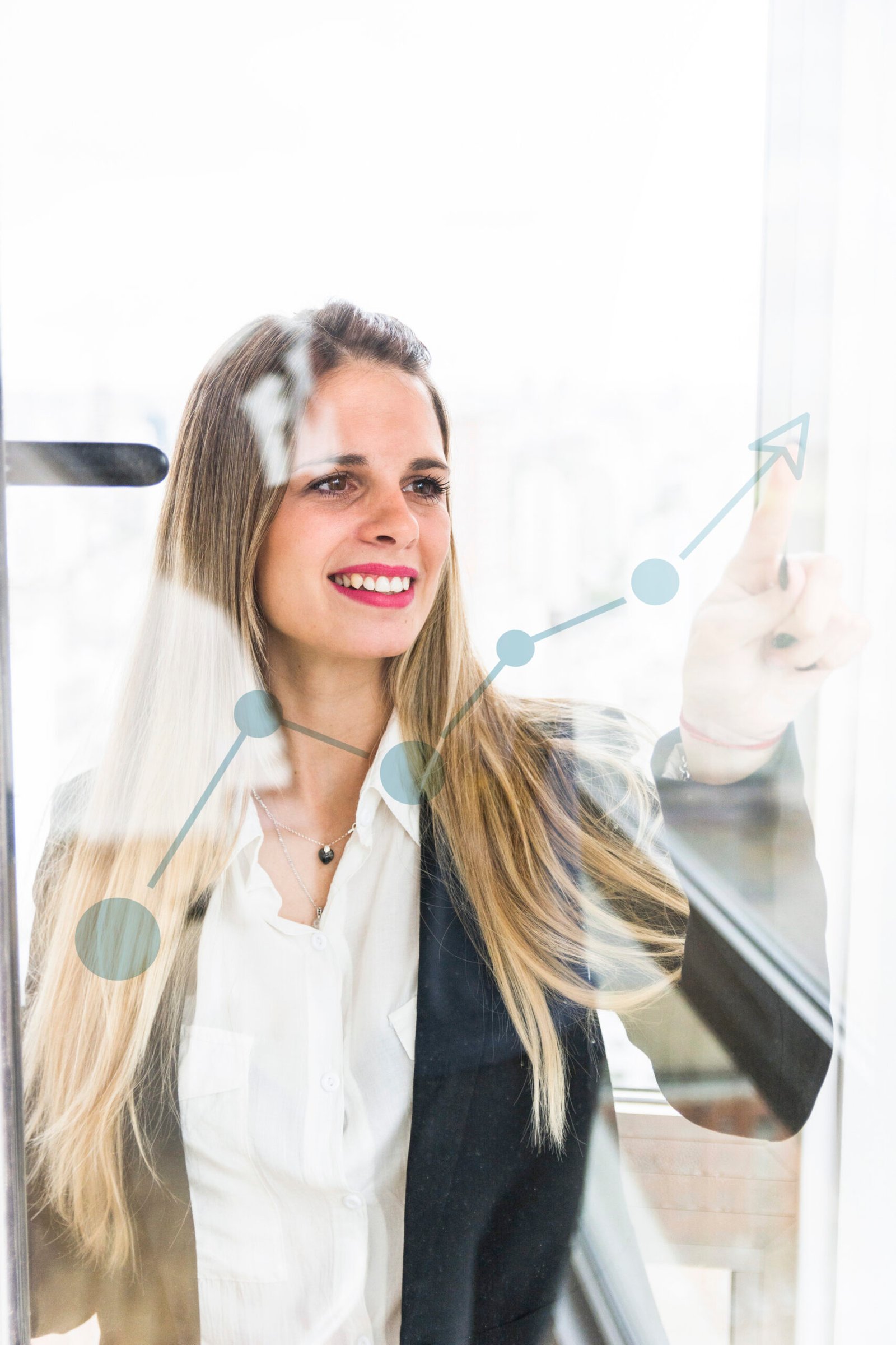 smiling young businesswoman pointing finger increasing graph transparent glass